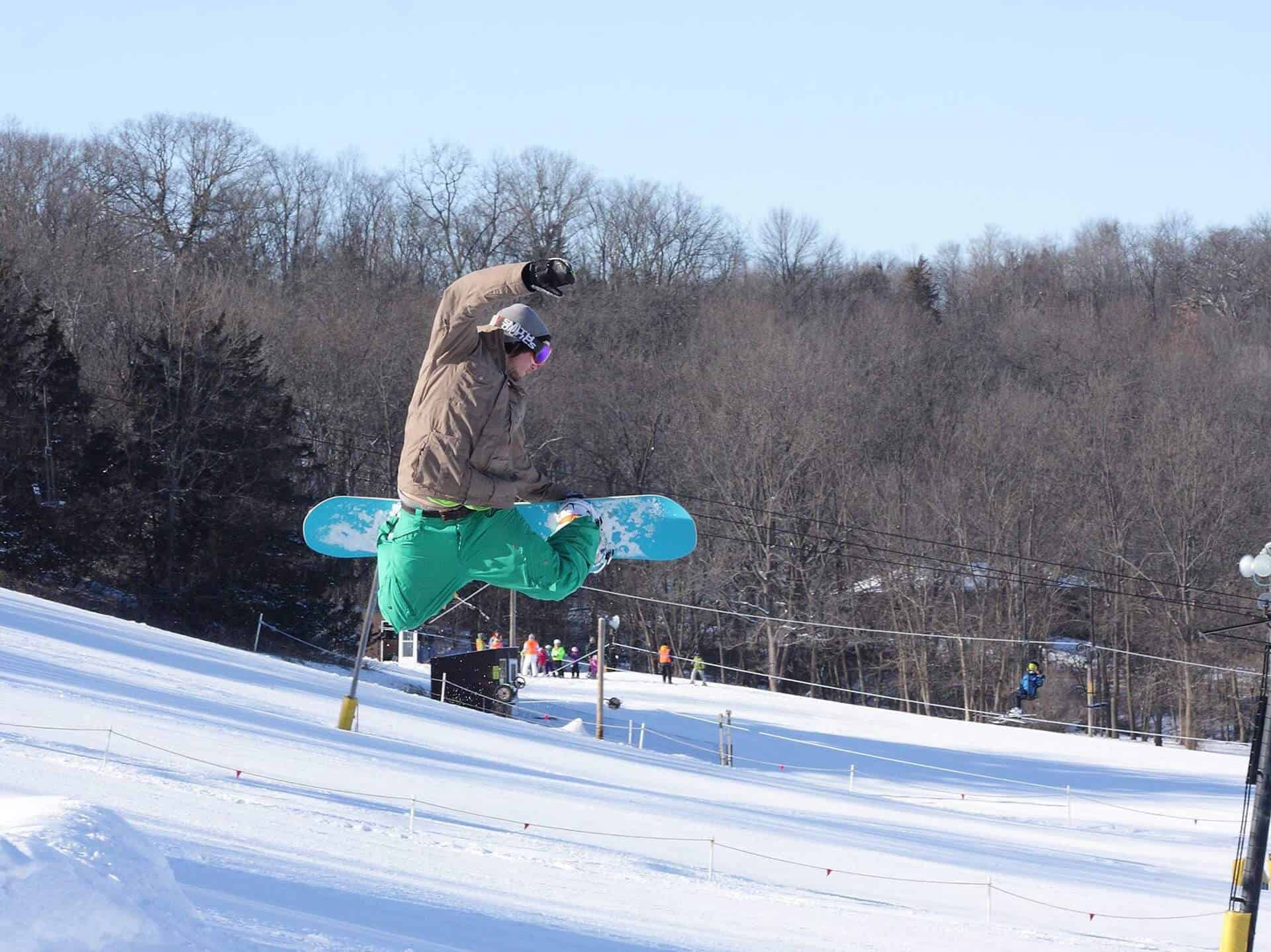 Snowboarder catching air at Seven Oaks Recreation