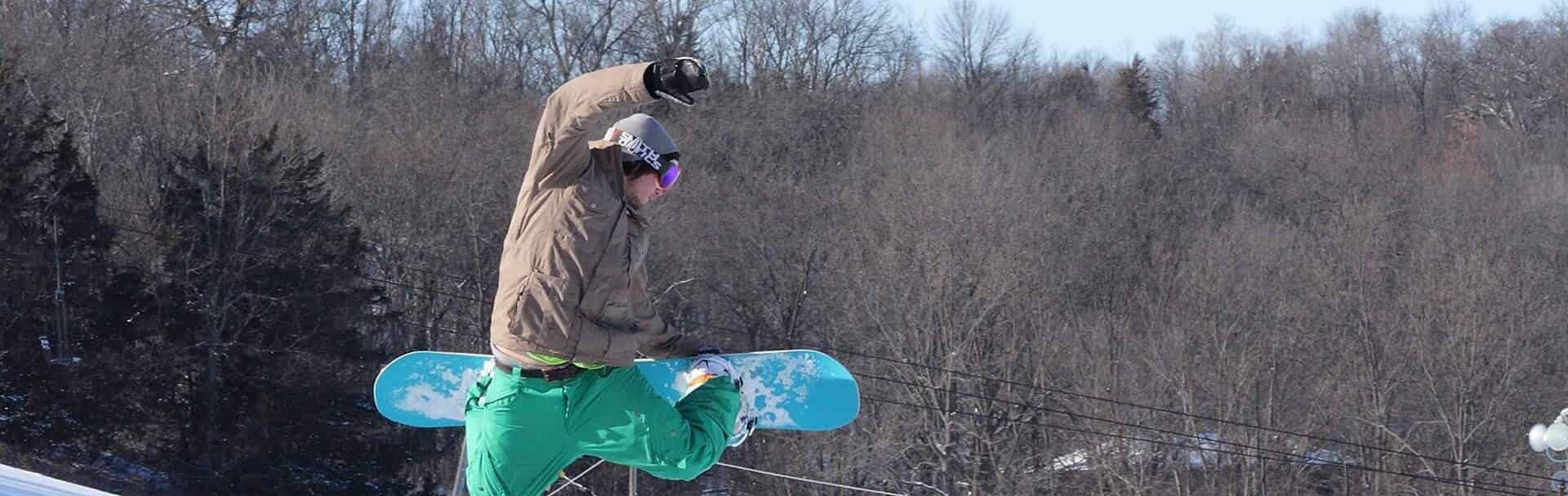 Snowboarder catching air at Seven Oaks Recreation